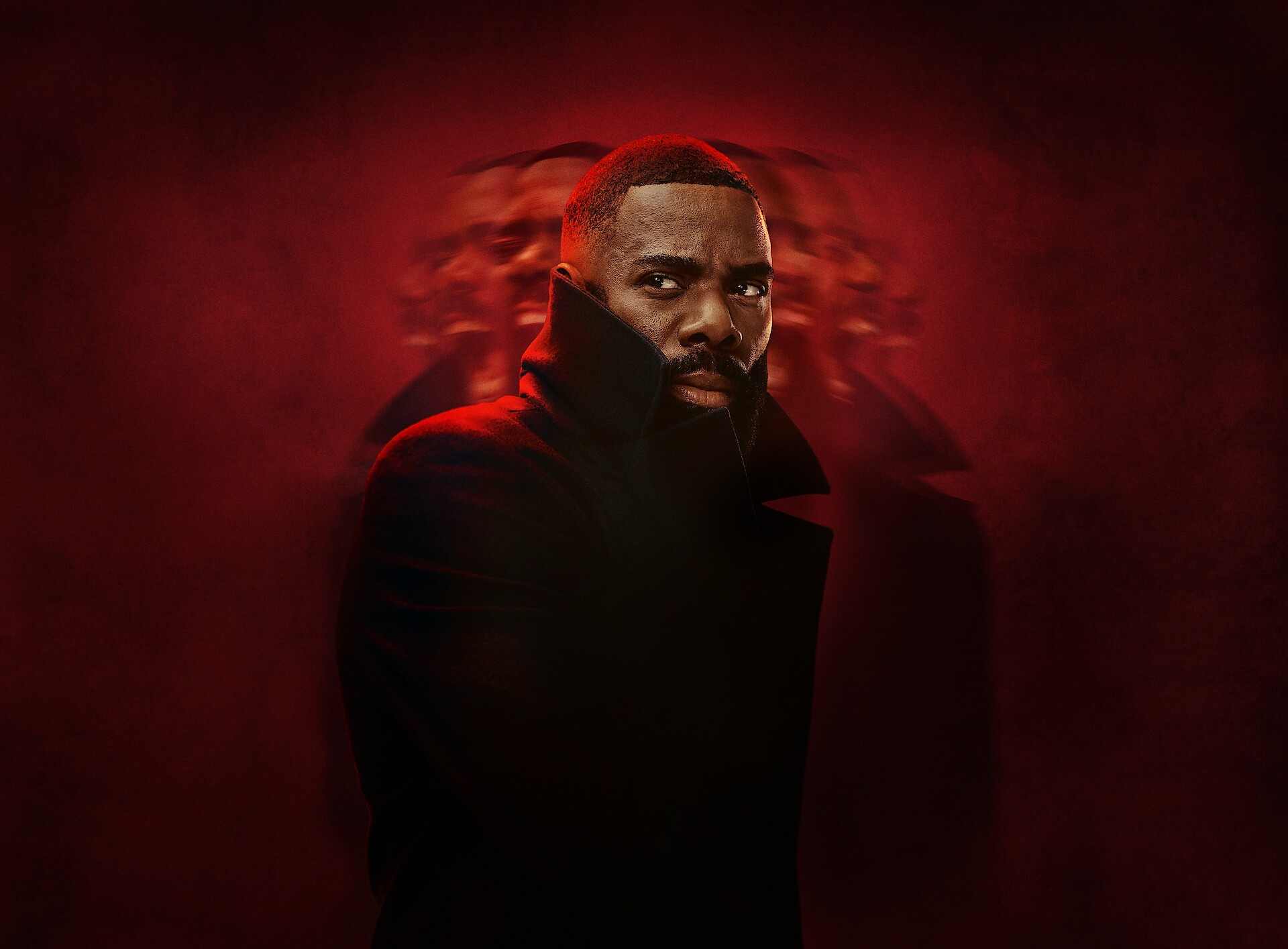Coleman Domingo in an overcoat on top of a red background
