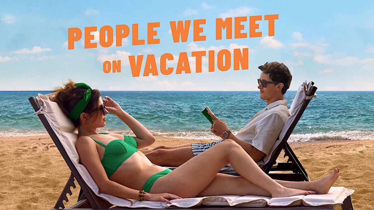Two people on sun loungers on the beach