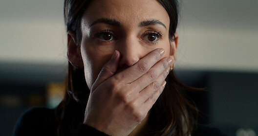 Michelle Keegan as Maya Stern hold her hand over her mouth with a shocked expression in the series 'Fool Me Once'