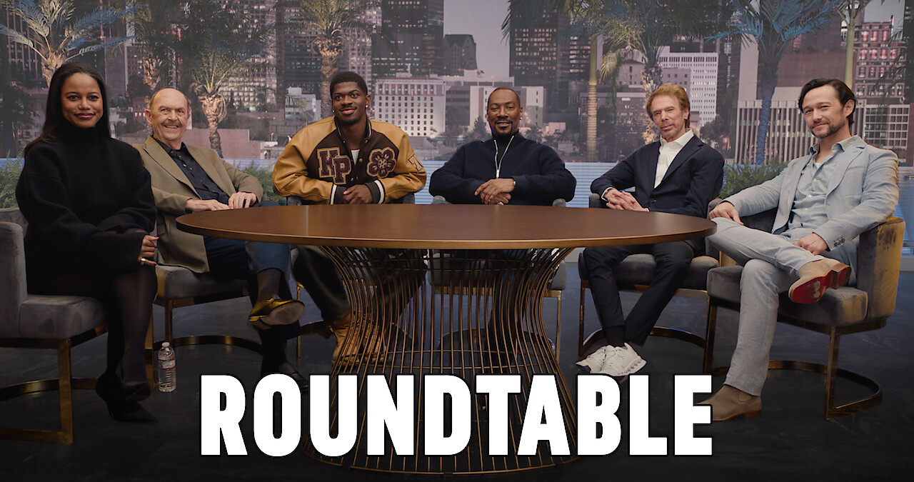 Taylour Paige, John Ashton, Lil Nas X, Eddie Murphy, Joseph "Beverly Hills: Axel F", Jerry Bruckheimer, and Lil Nas X sit around a table. 