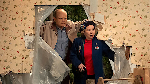 Red and Kitty walk through an open hole in their house in Part 3 of 'That '90s Show'