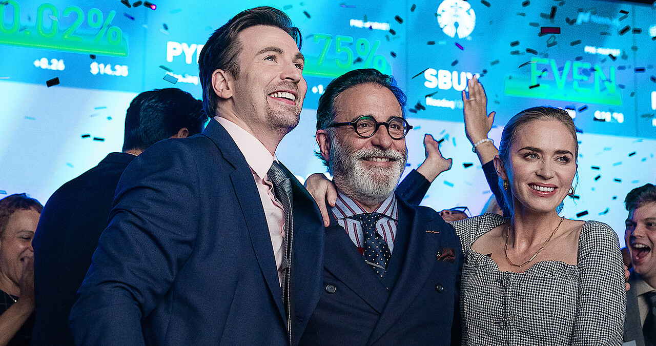 Chris Evans, Andy Garcia and Emily Blunt celebrate in a scene from 'Pain Hustlers.'