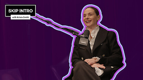 Rebecca Ferguson smiling and sitting in a podcast studio, speaking into a microphone with "SKIP INTRO with Krista Smith" logo in the corner, outlined in purple, set against a dark purple background, creating a lively and engaging atmosphere.