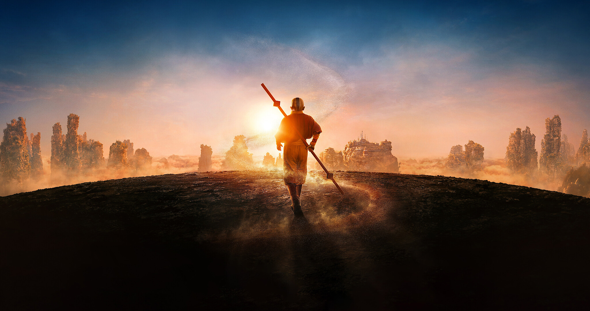Aang walks into the sunset with his airbender staff on his back