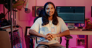 Tyler Dean Flores sits in a recording studio discussing the music in Season 1 of 'Neon.'