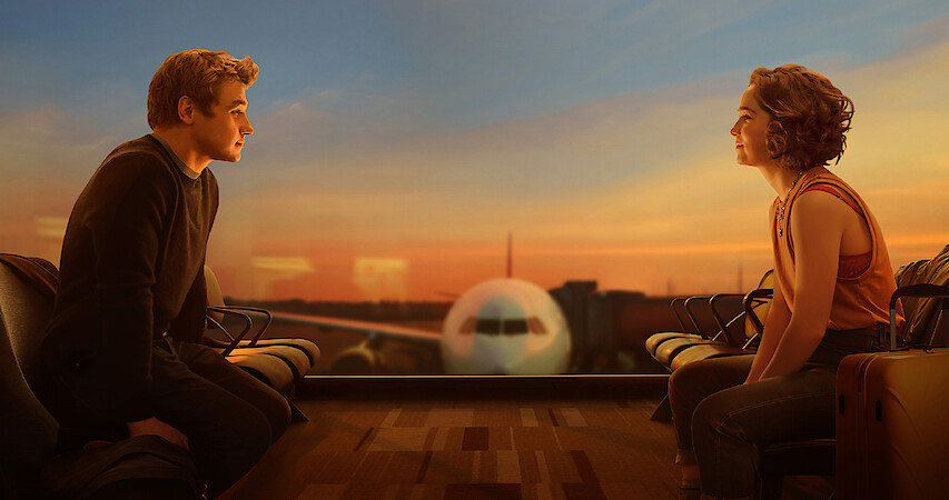 Two people stare at each other longingly on either side of an airplane.