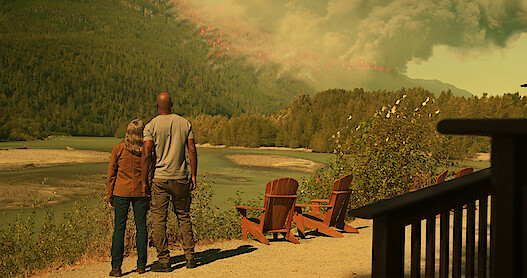Annette O’Toole as Hope and Colin Lawrence as Preacher watch a wildfire blazes through the mountainside in Season 5 of 'Virgin River.'