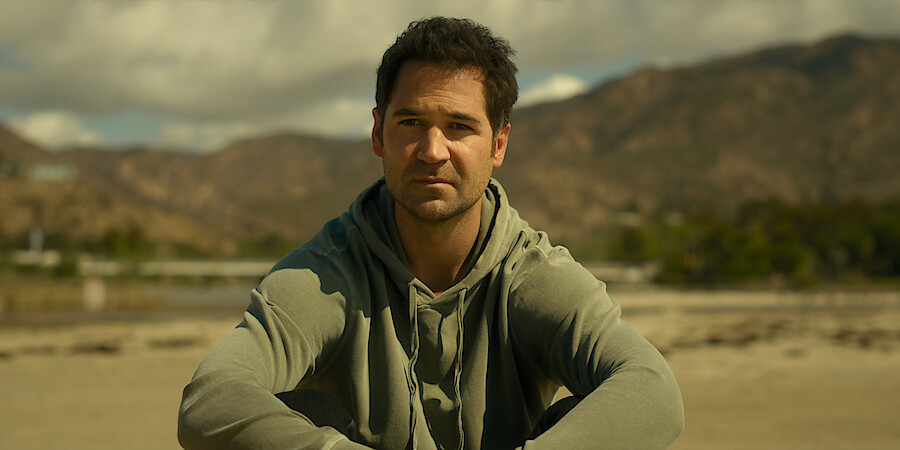 A close up of Manuel Garcia-Rulfo playing Mickey Haller on the beach in 'The Lincoln Lawyer'