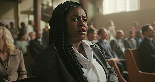 Uzo Aduba as Edie sits in a courtroom in Season 1 of 'Painkiller.'