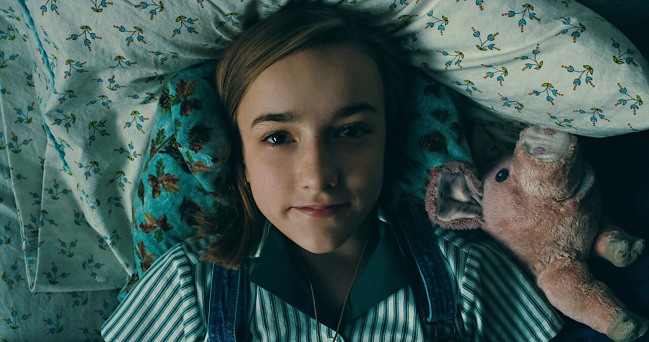 Little girl awake in bed
