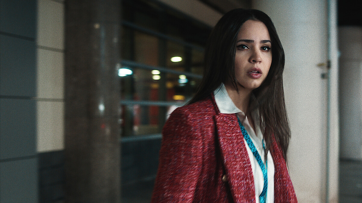 Sofia Carson in red blazer looking distressed.
