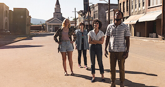 An image of the characters standing in the ghost town in Texas Chainsaw Massacre