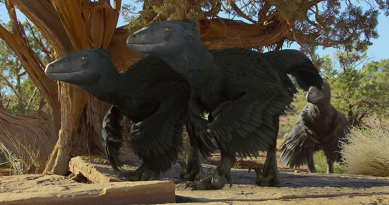 Two CGI dinosaurs with fathers walking under a tree.