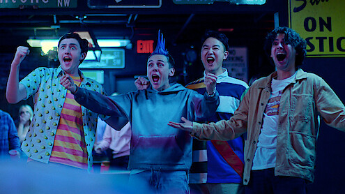 Gianni DeCenzo as Demetri, Jacob Bertrand as Hawk, Joe Seo as Kyler, and Xolo Maridueña as Miguel raise their arms and yell with excitement in Season 6 of 'Cobra Kai'