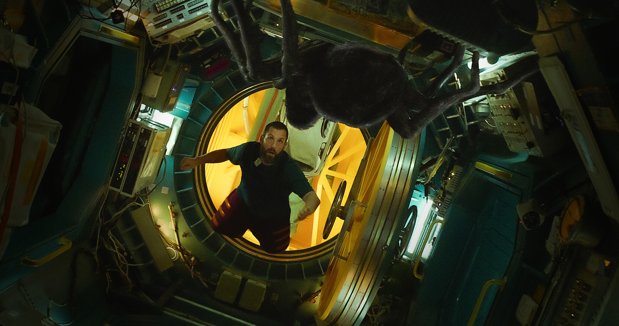 Adam Sandler floating in space in a spaceship. 
