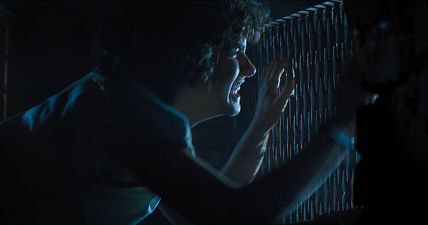 A terrified Melody peeks through a grate to get away