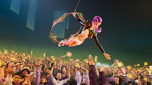 Rumi performs above a crowd of fans holding HUNTR/X light sticks in 'KPop Demon Hunters'