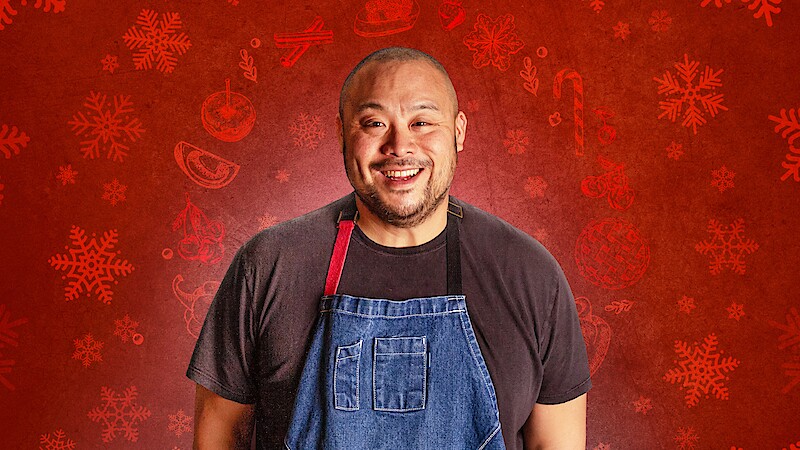 David Chang in a blue apron