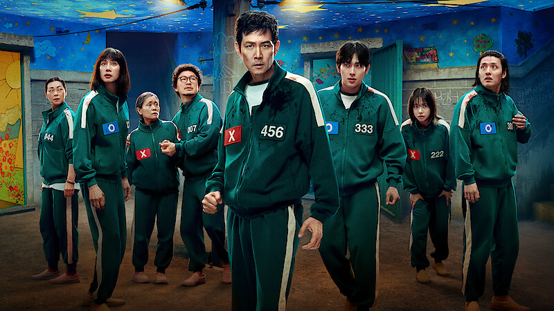'Squid Game' Season 3 players in green tracksuits with numbers.