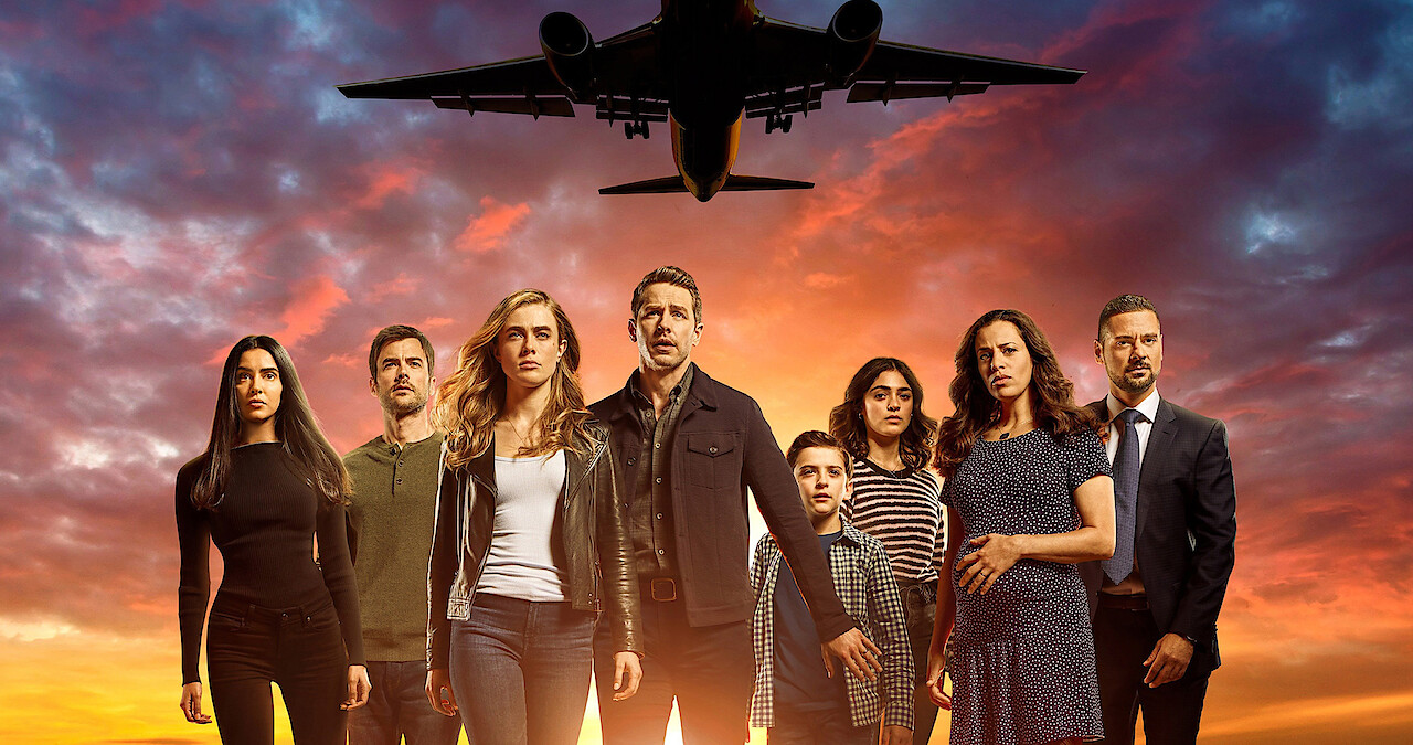 The cast of Manifest stand with an airplane taking flight behind them