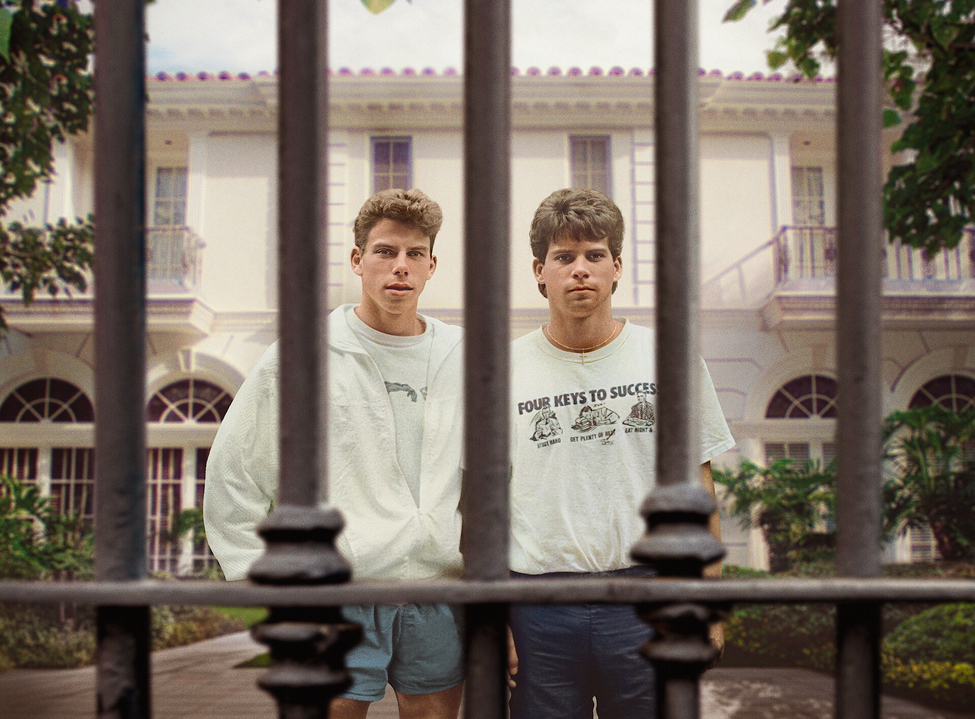 Lyle and Erik Menendez standing behind bars at their Calabasas estate