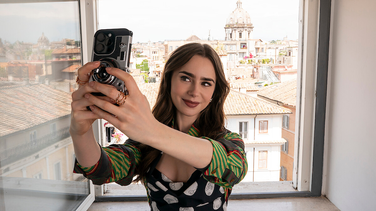 Lily Collins as Emily takes a selfie in Season 4 of 'Emily in Paris'