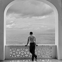 Tom Ripley stares out at the sea