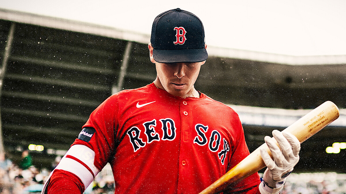 A Boston Red Sox player steps up to bat.