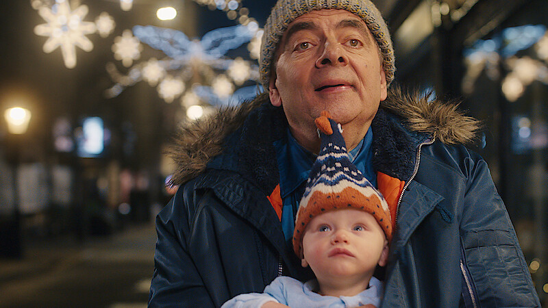 Rowan Atkinson as Trevor Bingley holds a baby in 'Man vs. Baby.'