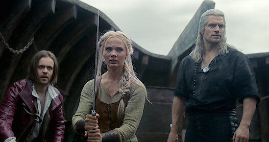 Jaskier, Ciri, and Geralt prepare for a fight in The Witcher.