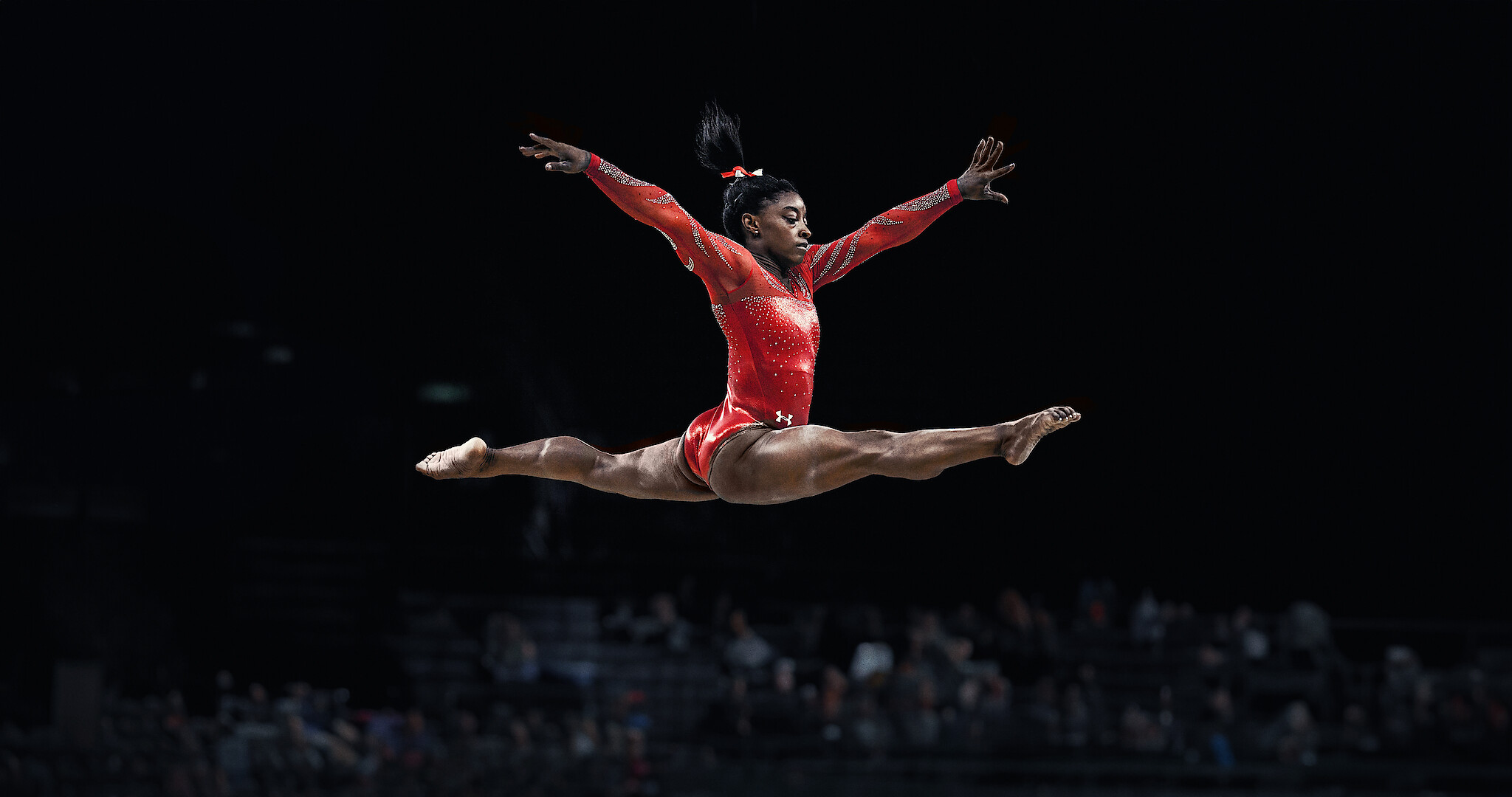Simone Biles jumping while performing. 