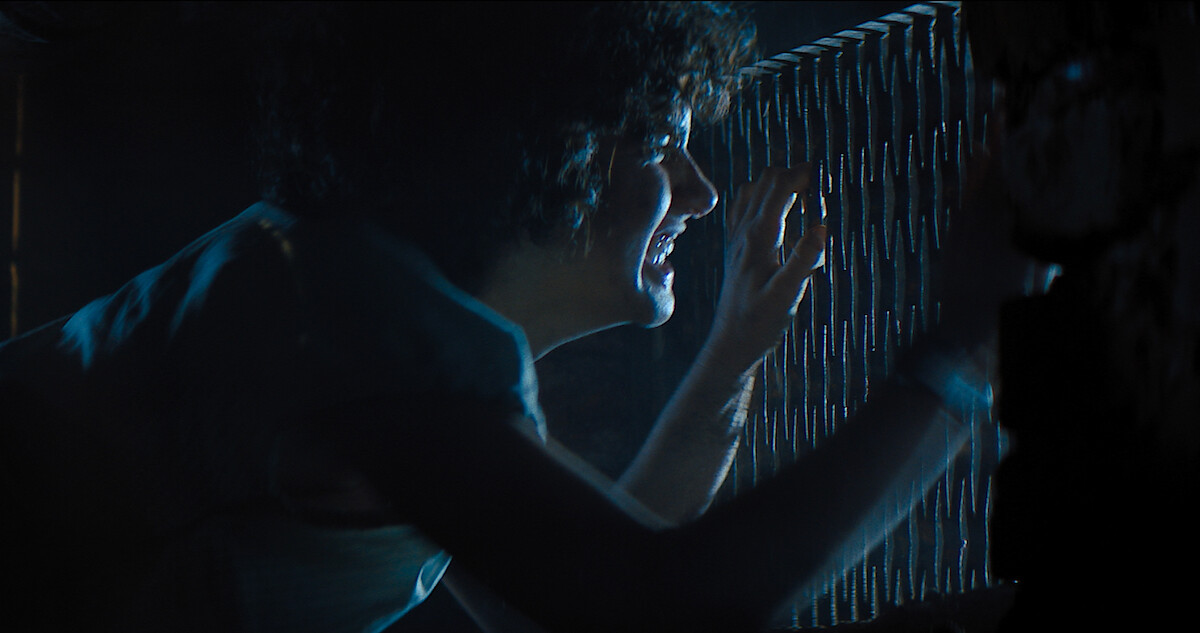 A terrified Melody peeks through a grate to get away