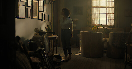 Melody is in the house looking at some pictures on the wall in the Texas Chainsaw Massacre