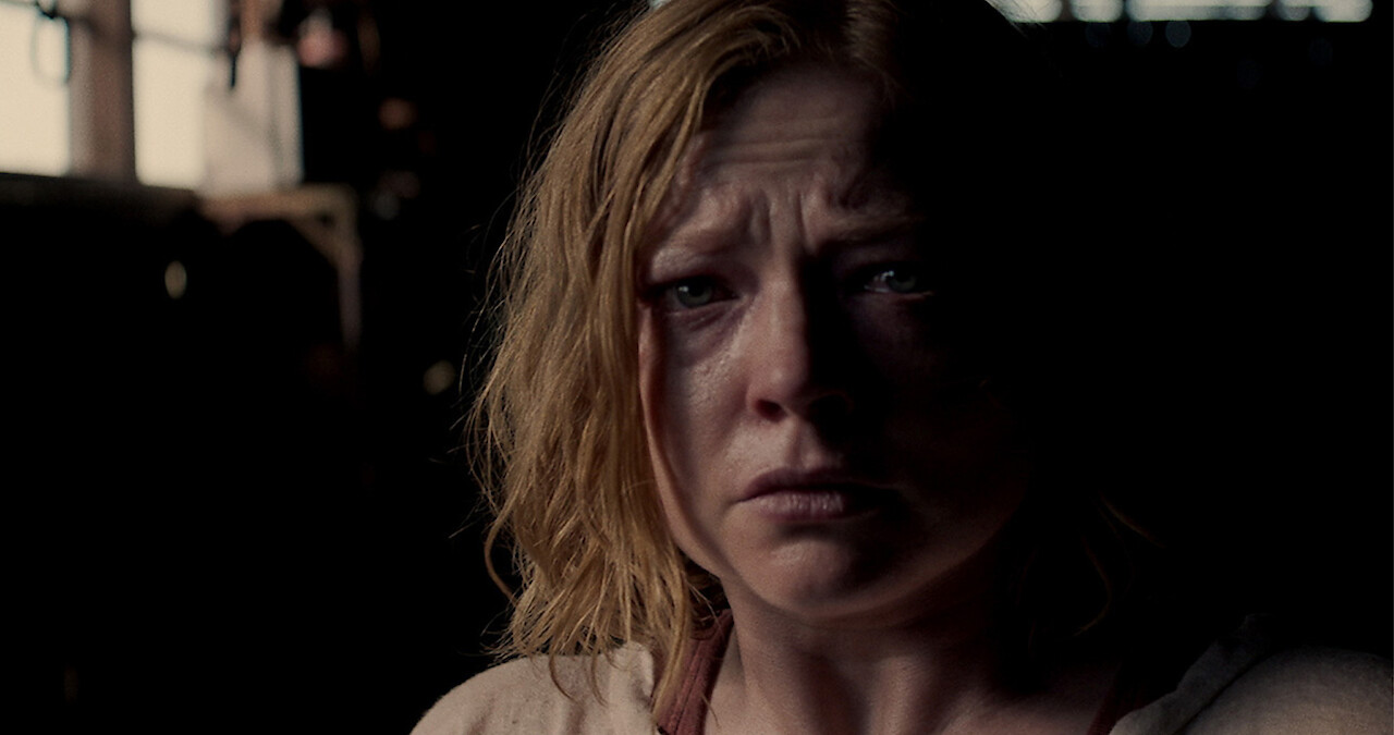 Sarah Snook stares ahead looking scared in a still from 'Run Rabbit Run.'