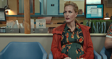Gillian Anderson as Jean Milburn sits in the waiting room of a doctor's office while pregnant in Season 3 of ‘Sex Education.’