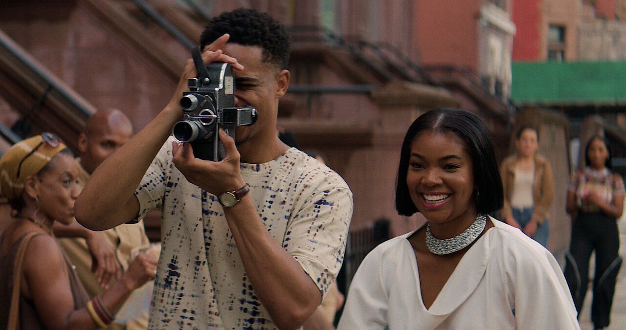 Keith Powers holds a camera next to Gabrielle Union in a still from 'The Perfect Find.'