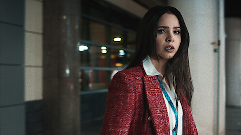 Sofia Carson in red blazer looking distressed.