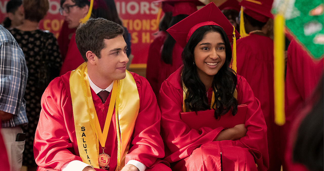 Jaren Lewison as Ben Gross and Maitreyi Ramakrishnan as Devi in Never Have I Ever Season 4 sitting at graduation.