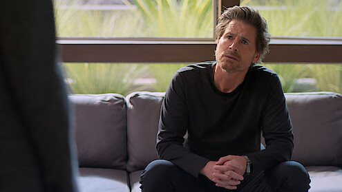 Rob Lowe sits on a couch in Season 2 of 'Unstable'