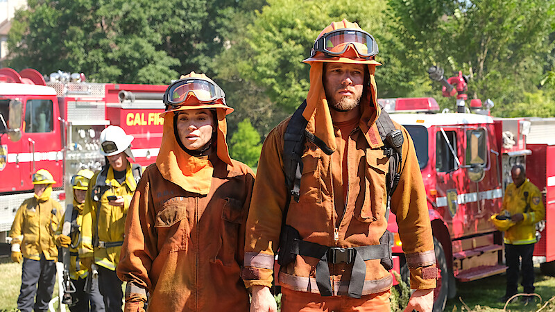 Stephanie Arcila as Gabriela Perez and Max Thieriot as Bode Donovan wear firefighting gear in 'Fire Country'