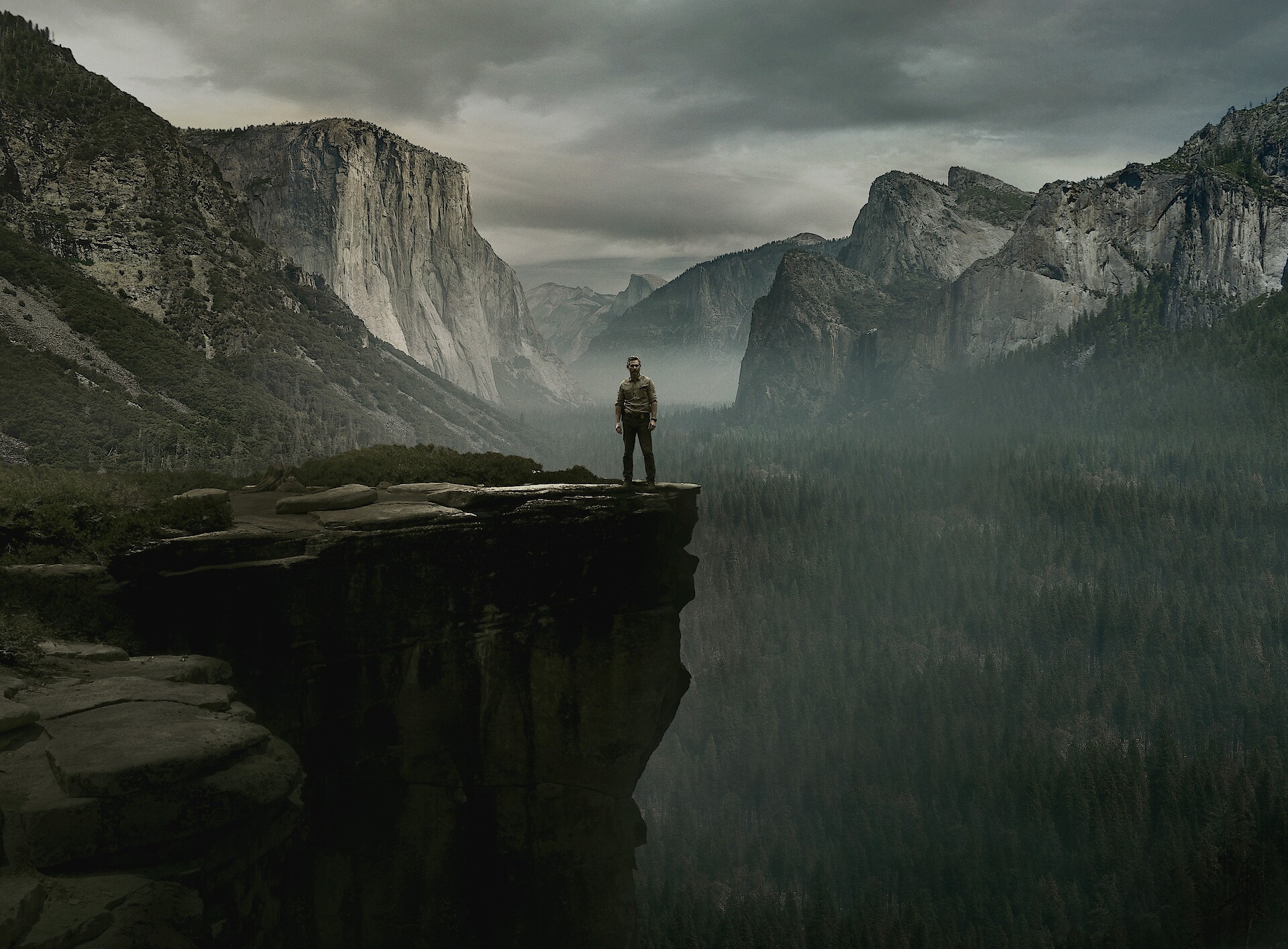 UNTAMED - a man standing on the edge of a cliff. 