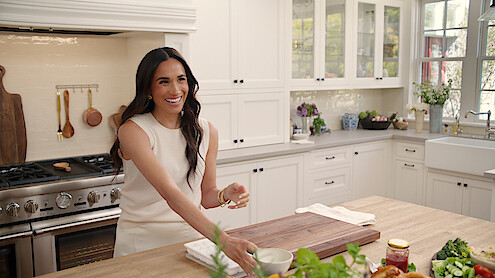 Meghan laughing in the kitchen. 