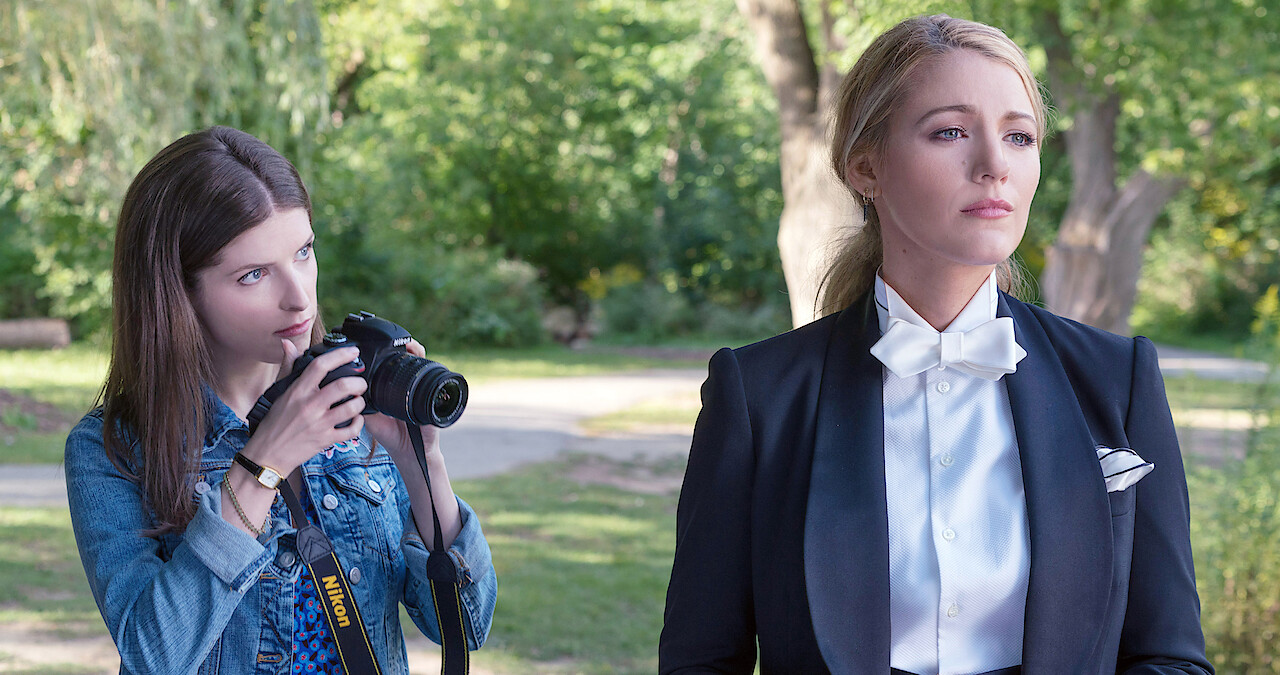 Anna Kendrick holds up a camera to photograph Blake Lively in 'A Simple Favor'