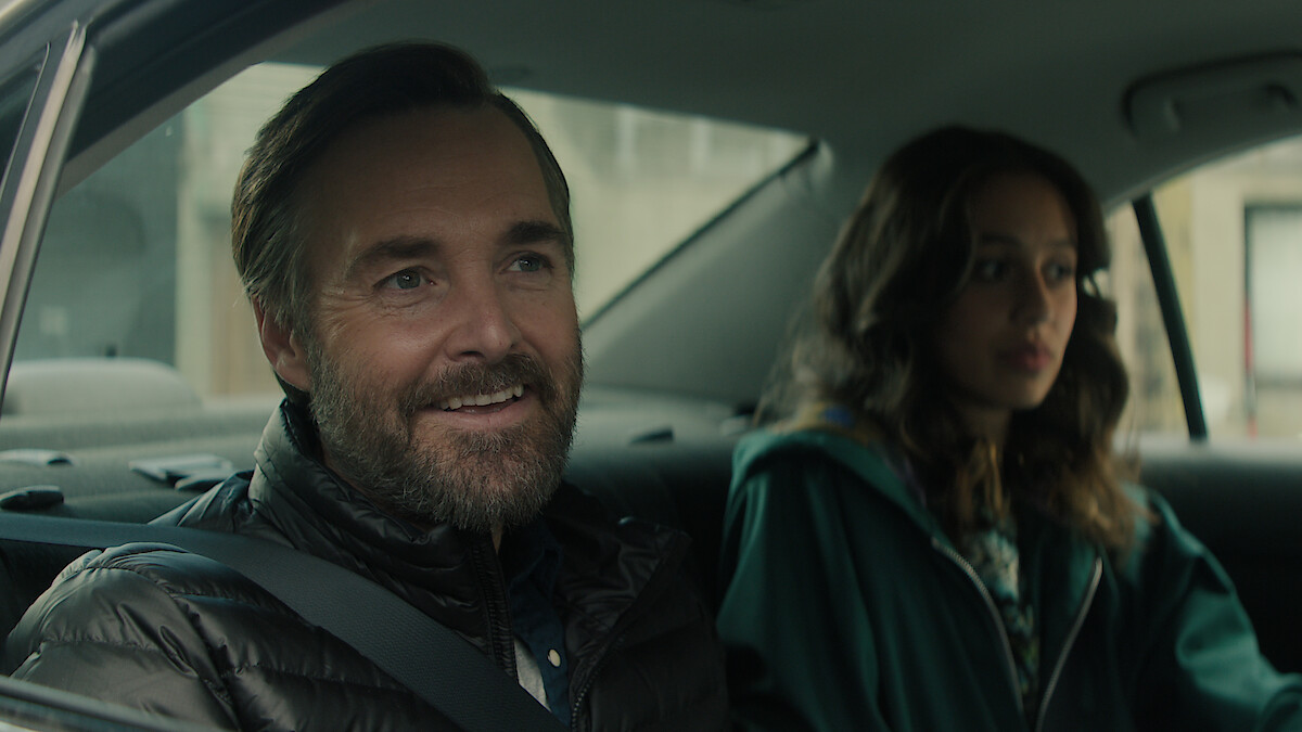 Will Forte as Gilbert Power smiles in the backseat of a car in 'Bodkin'