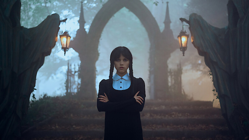 Jenna Ortega as Wednesday Addams stands in a graveyard in 'Wednesday'