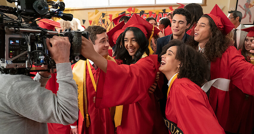 The cast of Never Have I Ever is all smiles in their graduation robes
